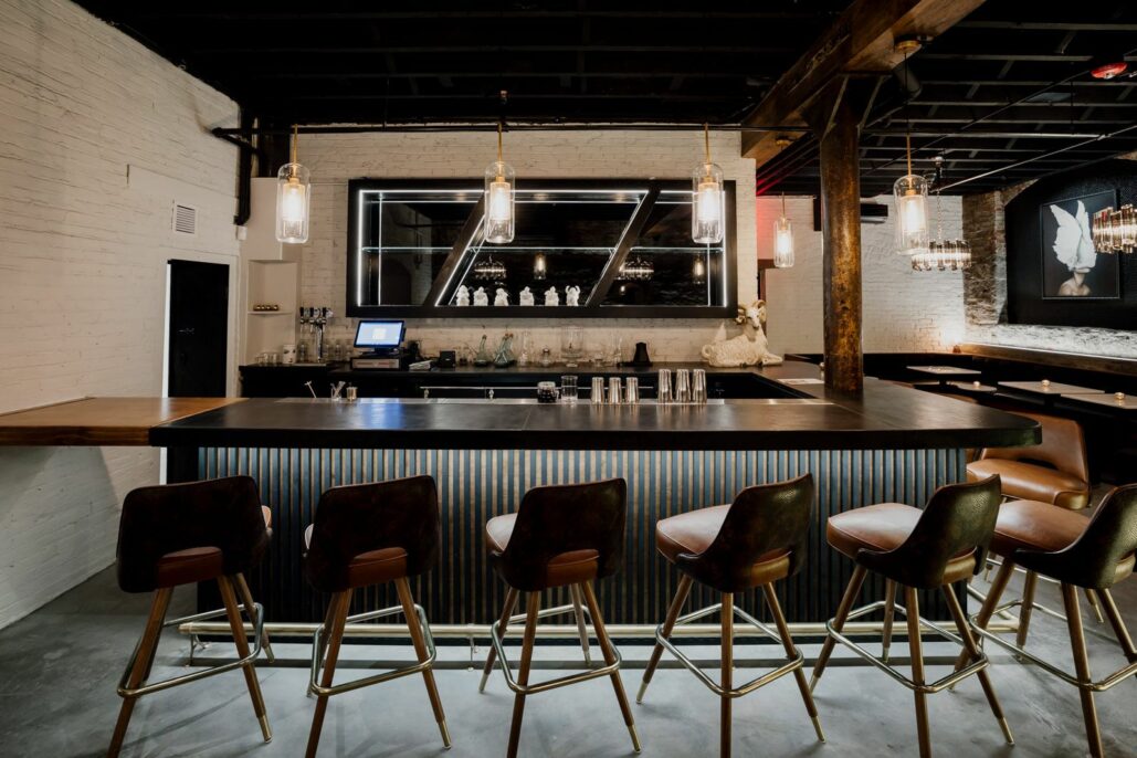 A beautiful dark, industrial style bar with Edison lighting